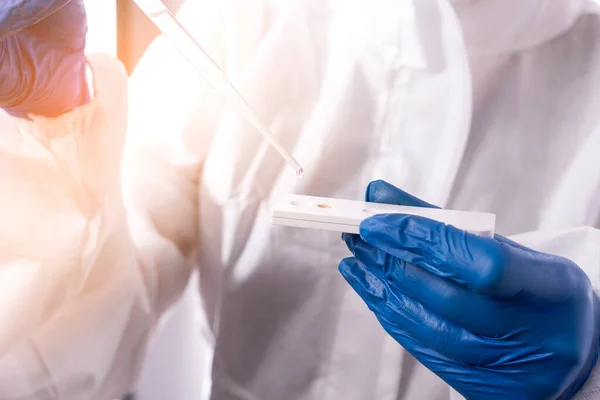 scientist dripping water on aquarium test kit